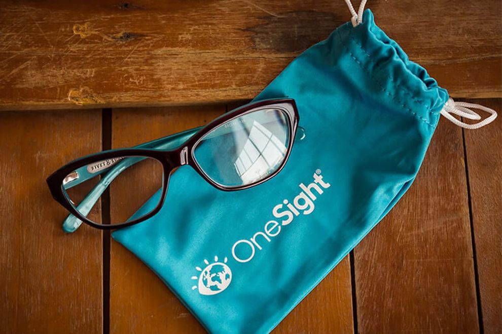A pair of glasses and a carrying case with the OneSight logo.