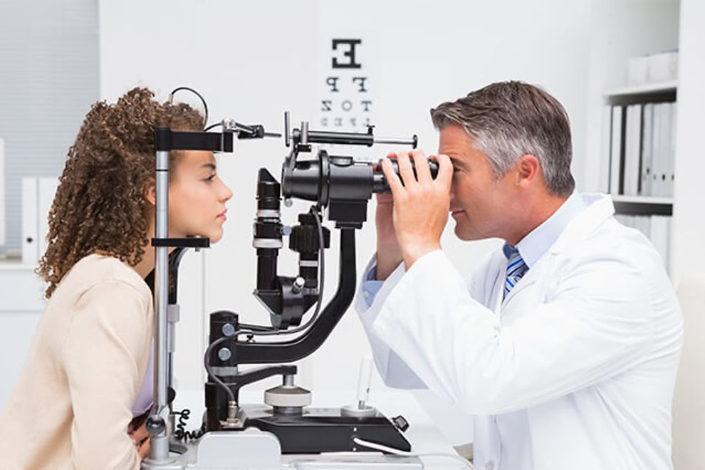 An eye doctor examines a patient's eyes